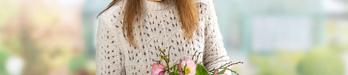 Arrange the ornaments, twigs and cones in between the moss and the glass of the bowl.